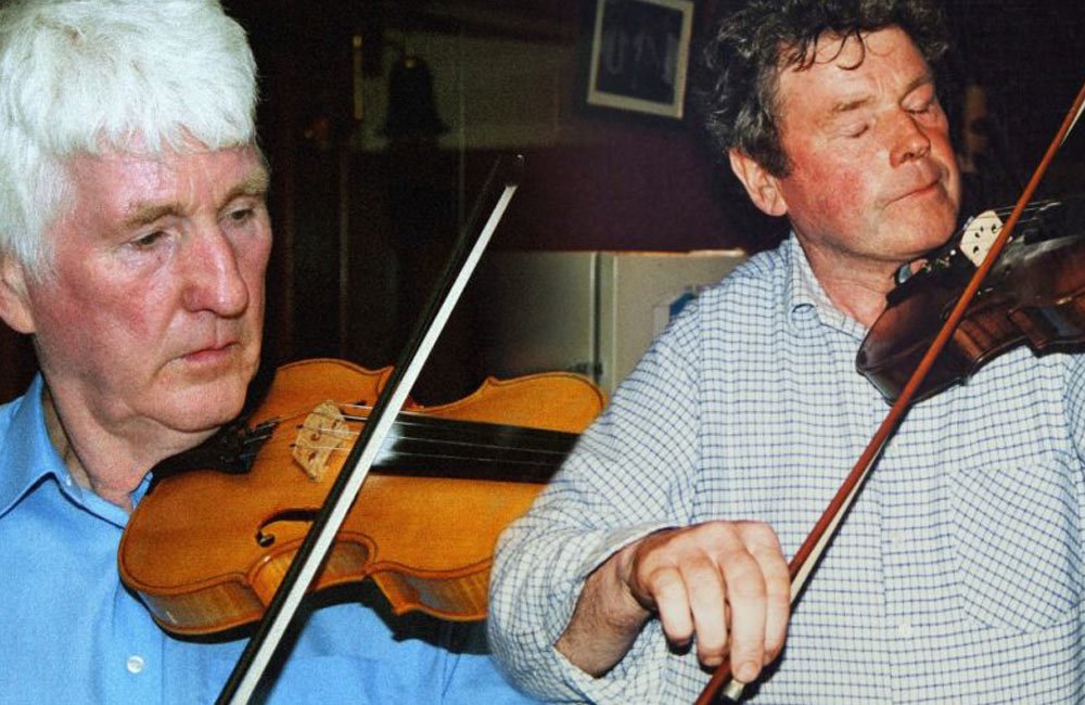 Two men playing fiddles.