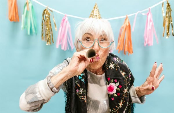 Photo-by-RODNAE-Productions--https---www.pexels.com-photo-older-woman-blowing-a-party-horn-7867916
