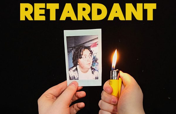 Image is of a pair of hands holding a lighter to a photograph of a young man.